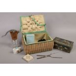 A vintage wicker sewing box and contents of collectables including vintage jubilee cream maker,