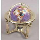 A small desktop gimbal globe on stand with compass and set with specimen hardstones.