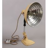 A vintage heat lamp converted to a table lamp with filament bulb.