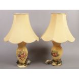 A pair of Aynsley table lamps of baluster form, peach ground, decorated with fruit and fabric