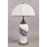 A brass and ceramic based three branch table lamp decorated with flowers and butterflies.