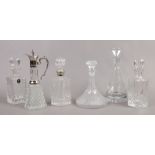 Five glass decanters and a claret jug including silver plated mounts.