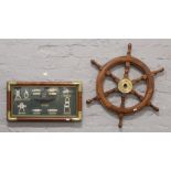 A decorative wooden ships wheel and a nautical themed plaque depicting different maritime knots.