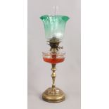 An Arts and Crafts brass based oil lamp with cut glass font and green tinted glass shade.Condition