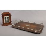 A mahogany cased vintage perpetual desk calendar along with an oak serving tray with white metal