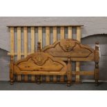 A carved pine double bed frame.