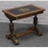 A carved oak refectory style occasional table with painted top.