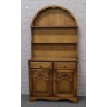 A light oak dome top dresser of slender proportions, Height 180cm x Width 92cm x Depth 40cm.