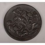 An early 20th century circular relief work plaque decorated with musical putti.