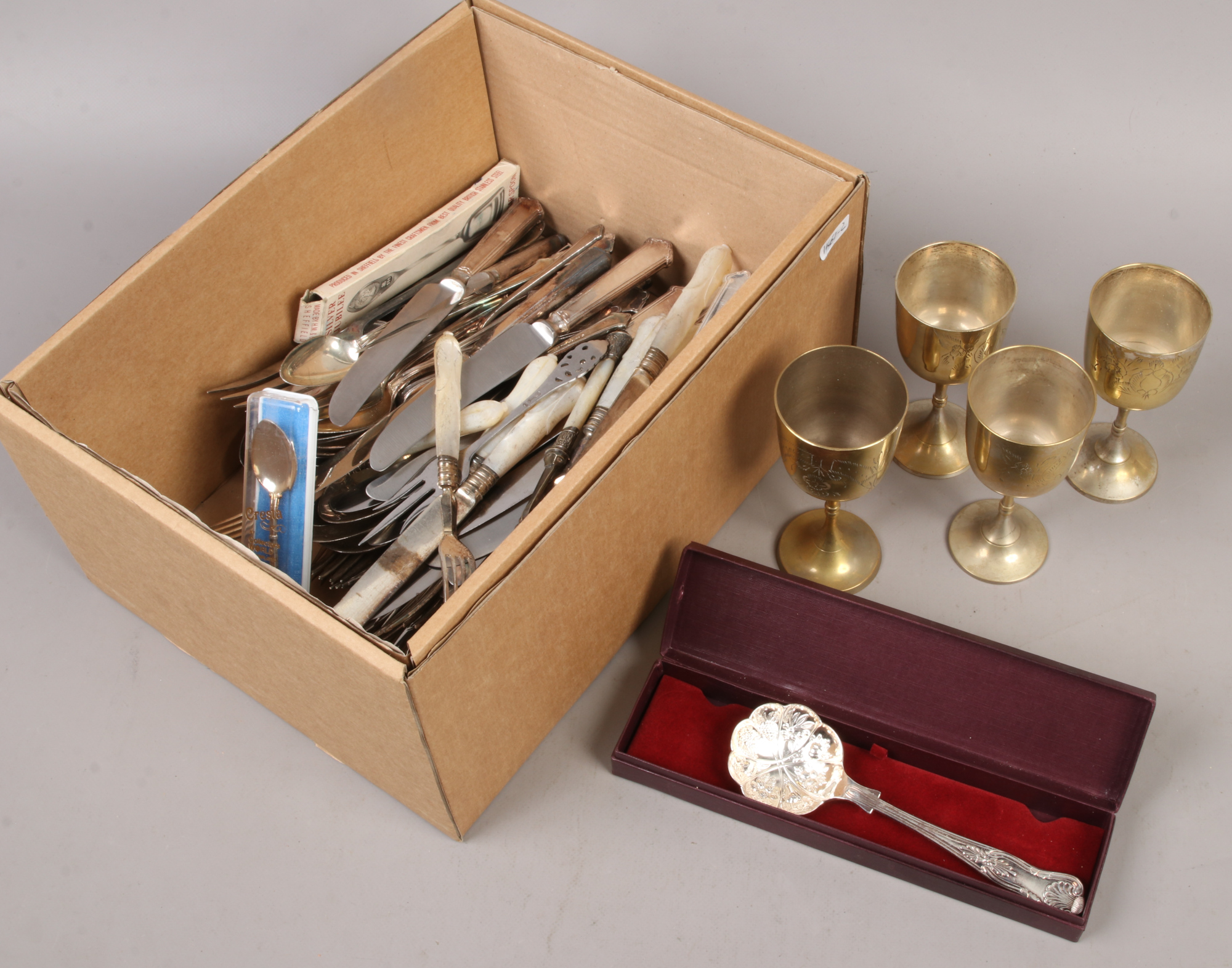 A box of metalwares mainly flatwares to include Elkington, mother of pearl handle examples etc.