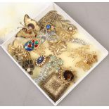 A box of costume jewellery brooches.
