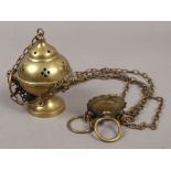 A hanging brass church thurible or censor.