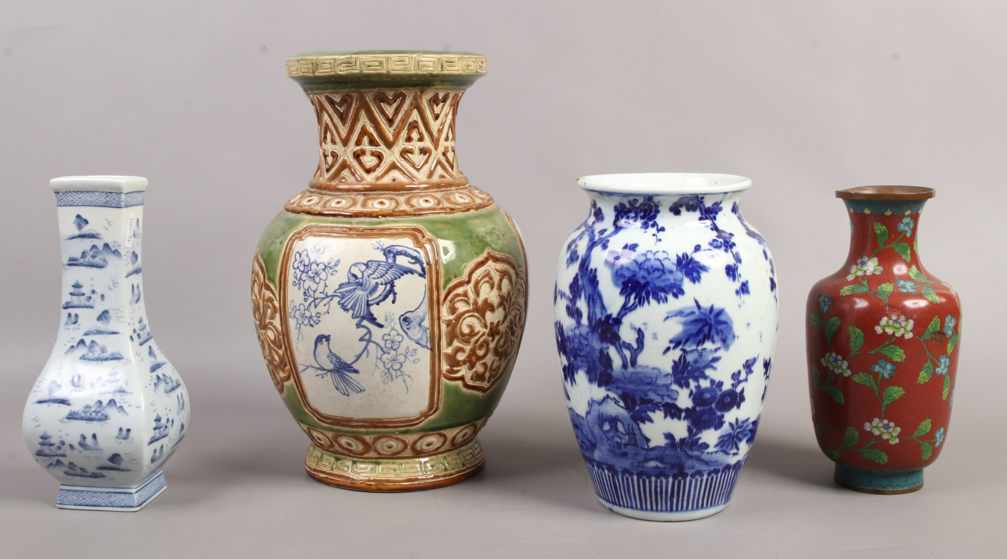 Two Chinese blue and white vases, along with a Chinese red ground cloisonne vase and a decorated