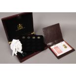 The worlds finest gold miniatures; a case containing four Elizabeth II five gold coins, along with a