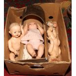 A box of dolls, doll parts and a rocking crib to include Pedigree etc.