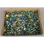 A box of polychrome glass marbles to include Victorian examples.