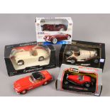 Four boxed model sports cars to include Burango Mercedes Benz SSK, Jaguar Roadster, ERTL European