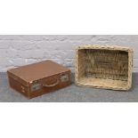 A Tuckwood Limited Sheffield wicker basket along with a leather suitcase.