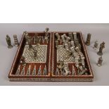 A hardwood folding chessboard / backgammon with mother of pearl inlay, along with metal figural