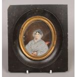 A 19th century ebonised framed hand painted portrait miniature on ivory of a seated old lady