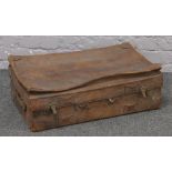 A vintage leather suitcase with canvas interior in need of restoration.