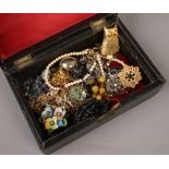 A box of costume jewellery to include brooches, necklaces, beads etc.