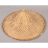 A Chinese straw bamboo coolie hat.