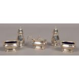 A silver five piece set to include preserve pot, two shakers, two Bristol blue glass lined pots,