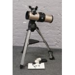 A Tasco Starguide telescope with computerised control on tripod with instruction manual and