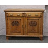 A Victorian carved oak sideboard.