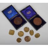 Two cased early 20th century Scottish college award medals, along with a quantity of brass pit check