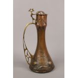 An Art Nouveau copper and brass ewer in The Benson style.