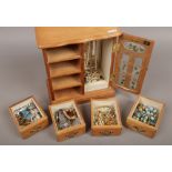 A wooden jewellery cabinet and contents of costume jewellery to include simulated pearls, rings,