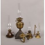 A quantity of brass and glass oil lamps to include chamber lamp examples etc.