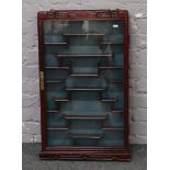 A Chinese hardwood display cabinet, Height 82cm x Width 49cm x Depth 9cm.