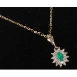 A 9ct gold emerald and diamond cluster pendant on chain.