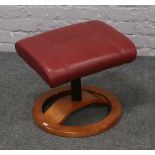 An ox blood leather foot stool.Condition report intended as a guide only.Chips to wooden base. Marks