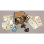 A box of British and world coins and bank notes.