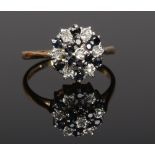 A ladies 9ct gold diamond and sapphire cluster ring, size M 2.43 grams gross weight.
