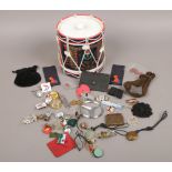 A Queens Own Highlanders drum ice bucket with contents of collectables to include car badges,