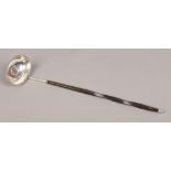 A Georgian silver toddy ladle with coin base, assayed London 1809.