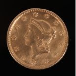 An American gold one dollar coin, dated 1853.