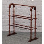 A turned hardwood towel rail.