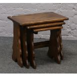 A solid oak nest of three tables.