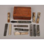An antique mahogany box containing nine vintage boxed cut throat razors, two rolling strops and