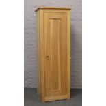 A solid light oak wardrobe fitted with lower shelves and hanging rail 61cm x 61cm x 190cm.