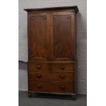 An early Victorian mahogany linen press with original fitted interior and working Bramah type