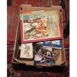 A box of militaria collectables to include whistles, books, badges, postcards etc.