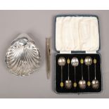 A cased set of six silver coffee spoons assayed Birmingham 1931, along with a silver shell form