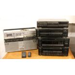 A Kenwood stacking system along with a Technics CD player and a Sharp GF 555 stereo / tape